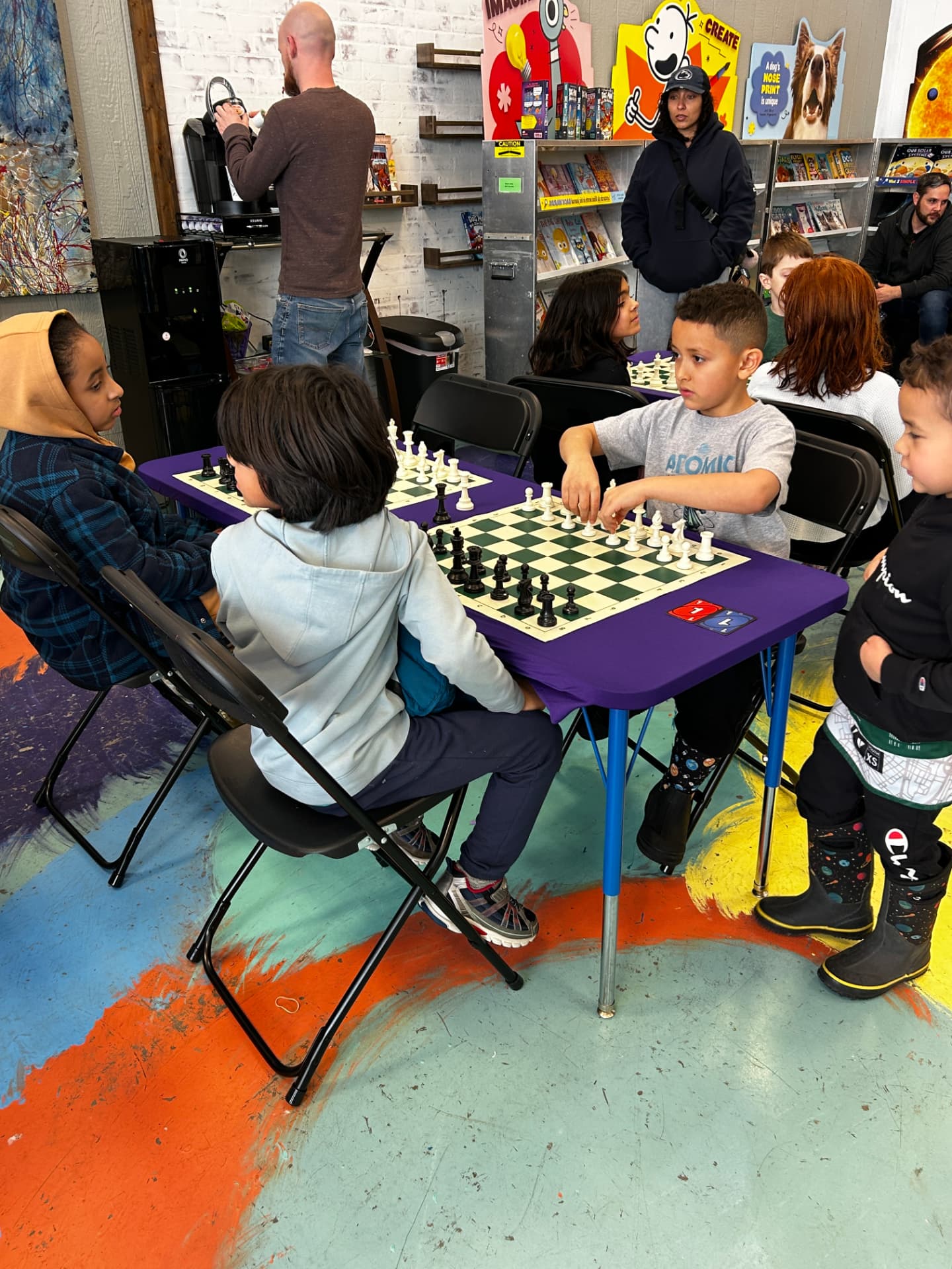 Students playing chess at a League match